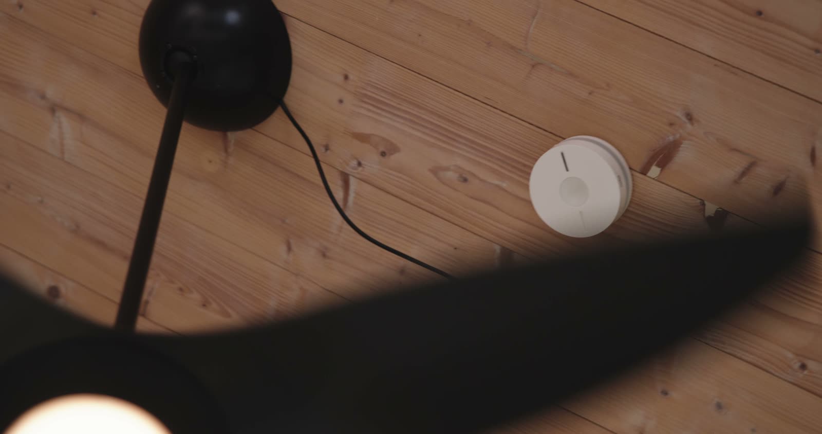 Home automation sensor mounted on a timber ceiling, from the demo house